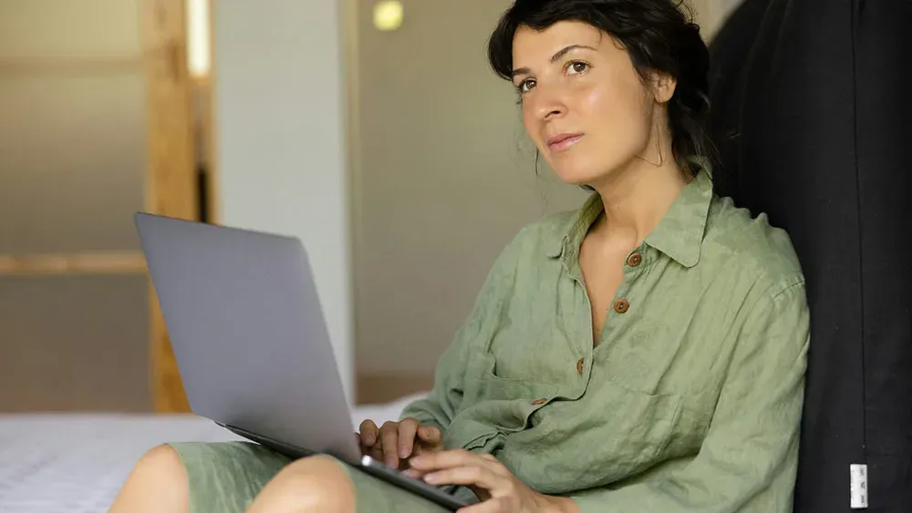 Woman standing confidently in a calm, softly lit room